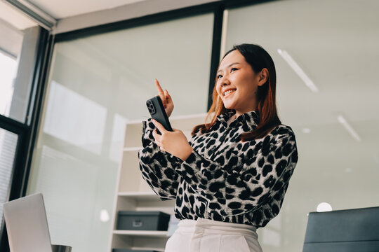 Confident asian business woman standing in modern office