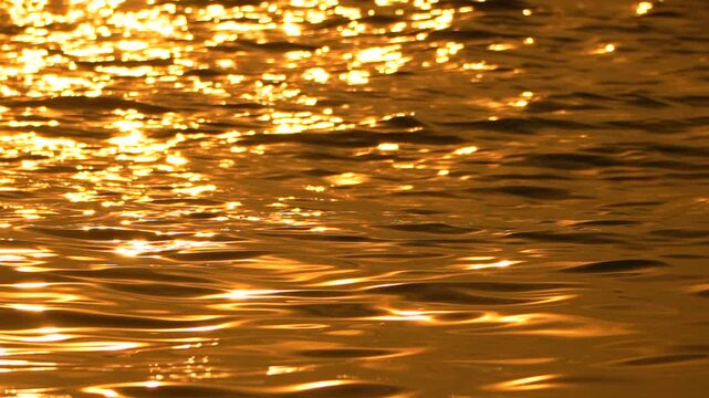 Water sunset golden abstract liquid surface ripples shimmering peacefully during evening light