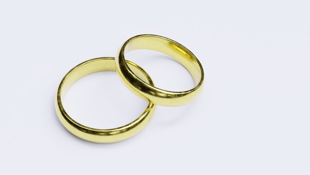 Two gold wedding rings isolated on white, symbolizing marriage, unity, romance and lasting commitment