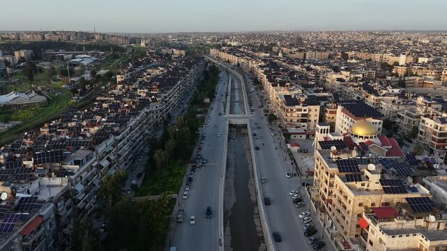 Drone view of a city landscape in Aleppo, Syria. Urban skyline and residential neighborhoods from above. City streets, infrastructure, and middle eastern architecture.