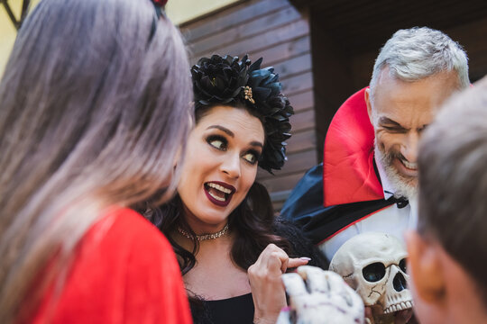 Family fun filled Halloween celebration outside a decorated cottage