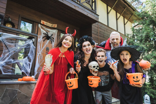Joyful family embraces the Halloween spirit with fun costumes and decorations