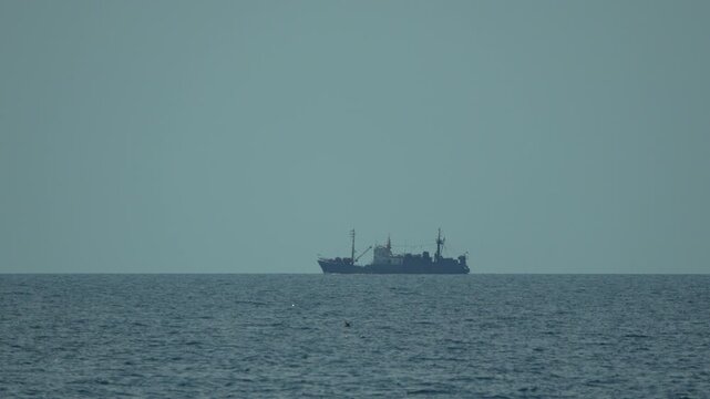 Ship Ocean Sea, vessel sailing calmly on the tranquil water horizon under clear blue sky, peaceful maritime transport