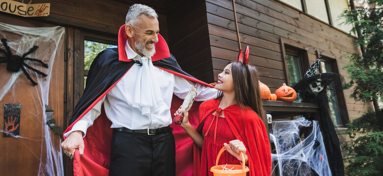 Celebrating Halloween joyfully with a mother and child in festive costumes