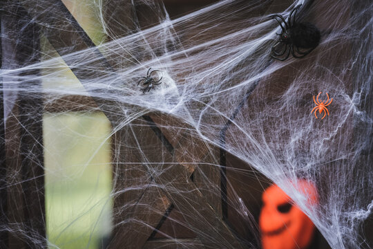 Spooky Halloween decorations adorn a cheerful house porch for festive fun
