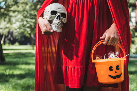 Cute kid in Halloween costume enjoys spooky season by decorated house