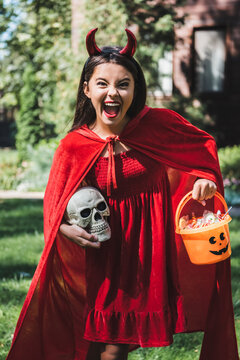 Exciting trick or treating moment with a cute kid in Halloween attire