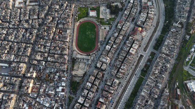 Drone view of a city landscape in Aleppo, Syria. Urban skyline and residential neighborhoods from above. City streets, infrastructure, and middle eastern architecture.