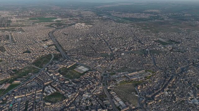 Drone view of a city landscape in Aleppo, Syria. Urban skyline and residential neighborhoods from above. City streets, infrastructure, and middle eastern architecture.
