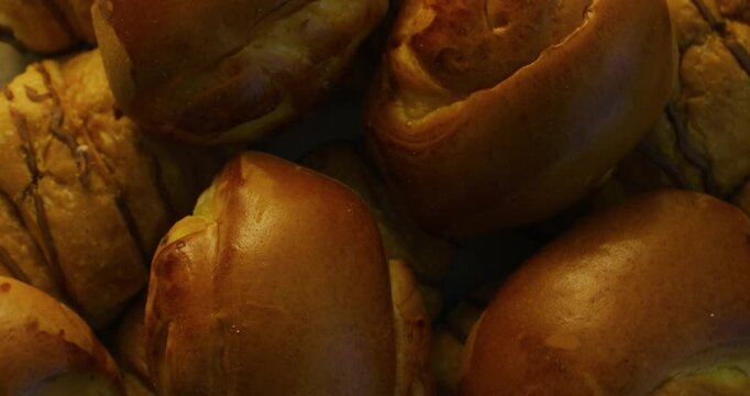 Delicious baked goods. Golden buns arranged on a plate. Sweet buns.
