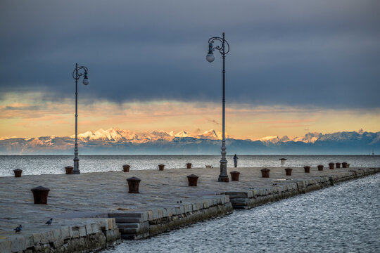 Trieste in winter. Between the sea, snow-capped mountains, and historic monuments.