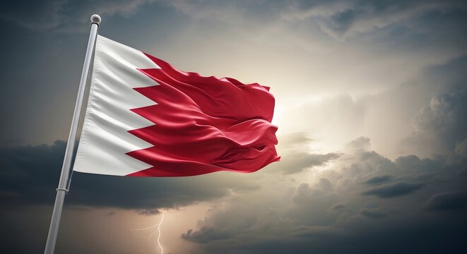 A dramatic shot of the Bahrain flag blowing in a storm with dark clouds and lightning in the sky.
