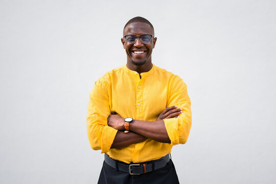 African american man, businessman entrepreneur stands with arms crossed, confident and smiling expression in casual isolated studio business portrait. Successful young CEO poses for corporate