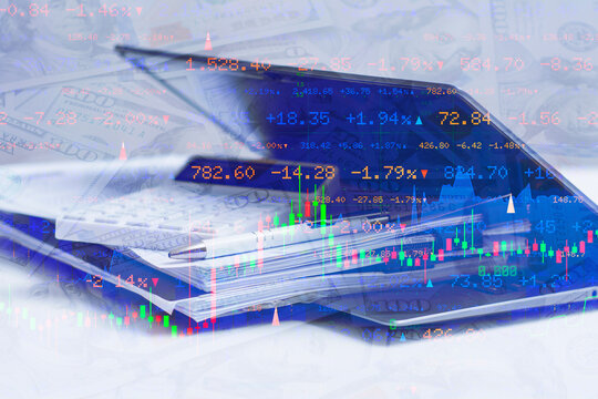 Financial analysis with calculator, business documents, pen and laptop overlaid with US dollar banknotes and stock market charts. Investment planning, trading and market data concept.