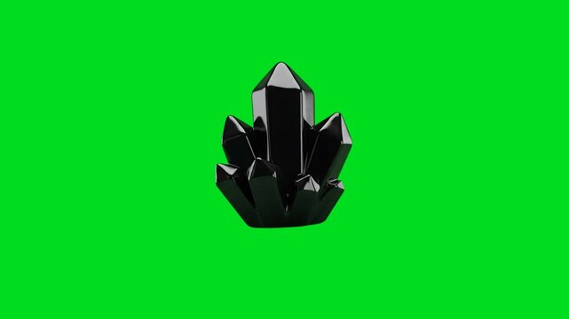 A cluster of glossy black crystals isolated against a vibrant green background