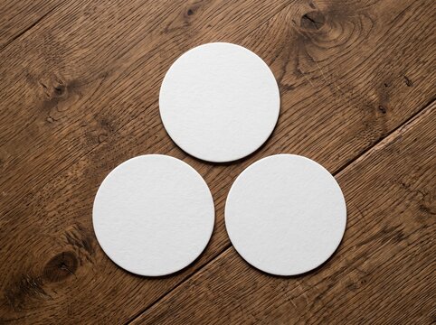 Blank round beer coasters mockup on wooden background