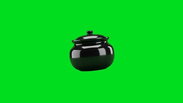 A shiny black ceramic cooking pot isolated against a vibrant green screen