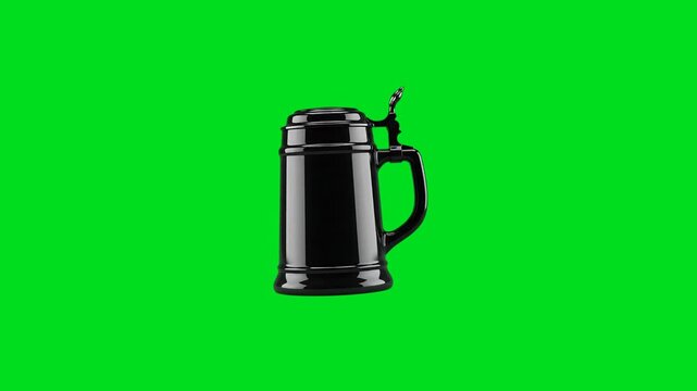 A sleek black ceramic beer stein isolated against a vibrant green background