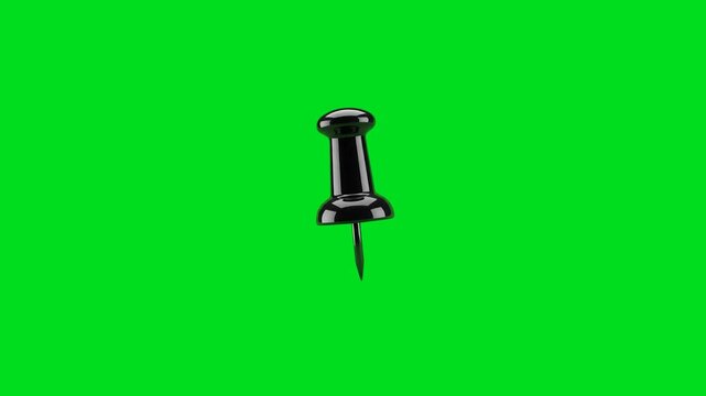 A single black push pin isolated against a vibrant chroma key green screen