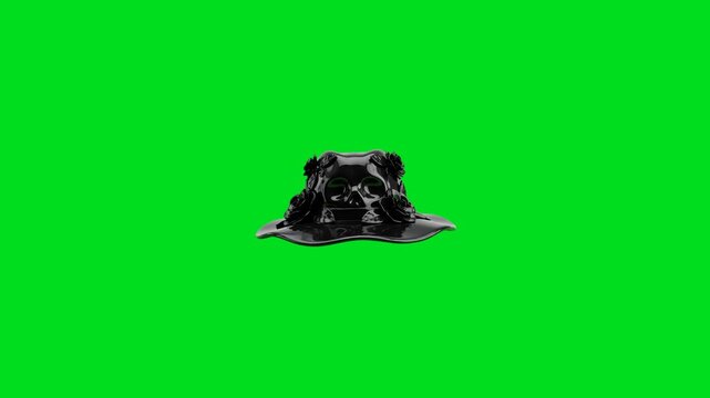 A shiny black hat with skull and floral details against a green screen