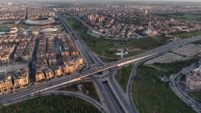 Drone view of a city landscape in Aleppo, Syria. Urban skyline and residential neighborhoods from above. City streets, infrastructure, and middle eastern architecture.