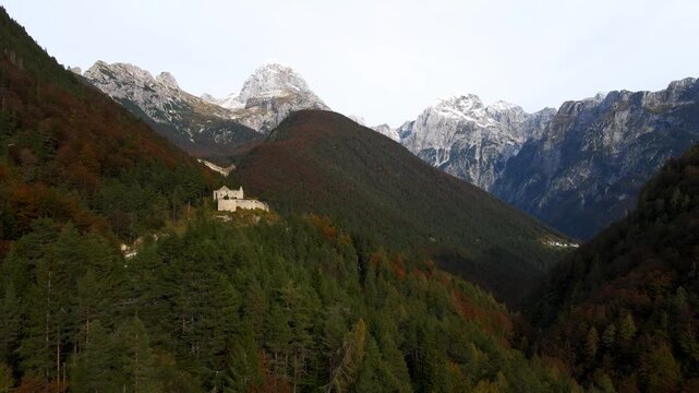 Drone fly towards Fort Predil beneath rugged alpine peaks landscape in Slovenia
