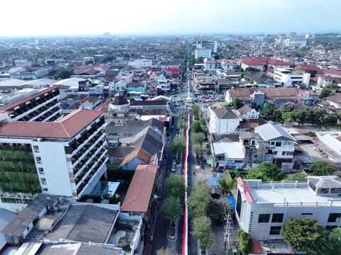 Yogyakarta, Indonesia - 15 August 2026: Aerial view of Tugu Yogyakarta monument and surrounding urban landscape with historic buildings and busy streets.