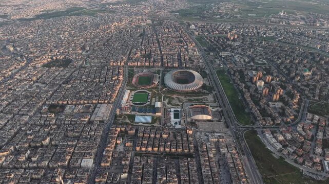 Drone view of a city landscape in Aleppo, Syria. Urban skyline and residential neighborhoods from above. City streets, infrastructure, and middle eastern architecture.