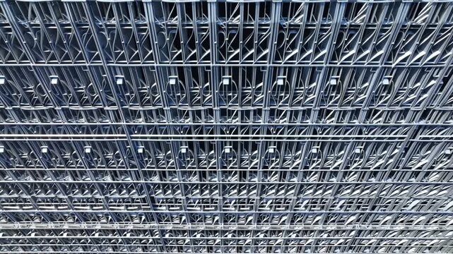Exposed industrial ceiling framework with dense electrical wiring and suspended lighting fixtures