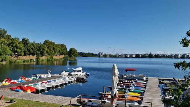 Colorful rental boats at a lakeside dock on Ziegelinnensee in Schwerin, Germany