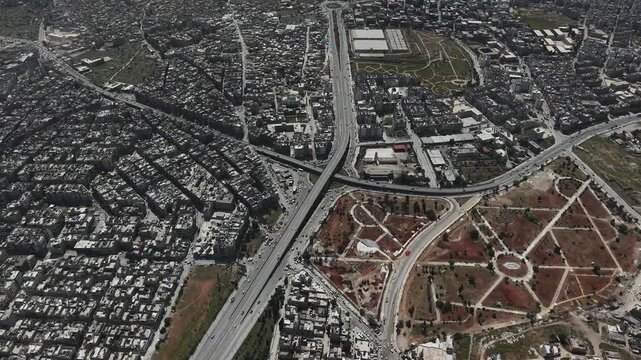 Drone view of a city landscape in Aleppo, Syria. Urban skyline and residential neighborhoods from above. City streets, infrastructure, and middle eastern architecture.