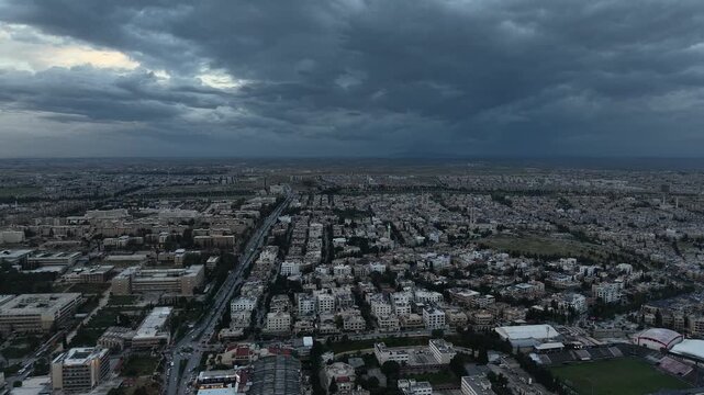 Drone view of a city landscape in Aleppo, Syria. Urban skyline and residential neighborhoods from above. City streets, infrastructure, and middle eastern architecture.