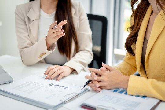 Professional businesswomen discussing financial data reports col