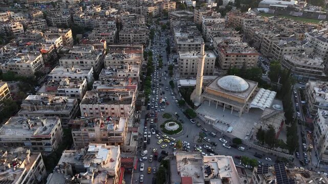 Drone view of a city landscape in Aleppo, Syria. Urban skyline and residential neighborhoods from above. City streets, infrastructure, and middle eastern architecture.