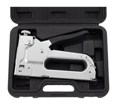 Construction staple gun in open plastic carrying case, heavy duty stapler tool in storage box isolated on transparent background