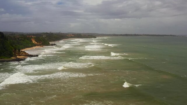 Top view of a beautiful sandy beach and ocean with waves. Matara beach, Sri Lanka.