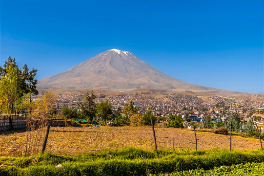 A view past farmland towards El Misti volcano on the outskirts of Arequipa, Peru in the morning