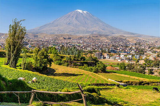 A view past farmland terraces towards El Misti volcano on the outskirts of Arequipa, Peru in the morning
