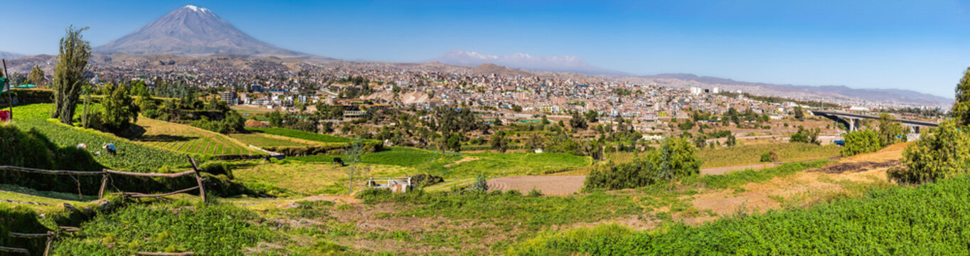 A panorama view of farmland terraces, El Misti volcano and the Chile Bridge on the outskirts of Arequipa, Peru in the morning