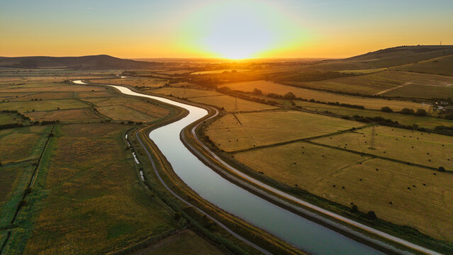 Beautiful drone view landscape over stunning lush English countryside at sunrise in Summer