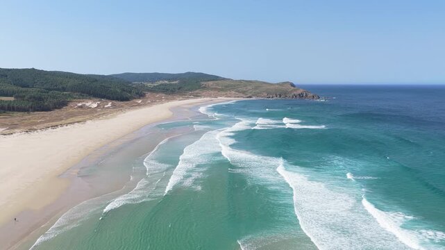 Wide aerial shot of Praia do Rostro, a pristine sandy beach on the Atlantic coast of Spain.