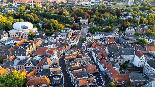 Aerial view of the historic city center featuring red-tiled rooftops, narrow streets, and the modern dome of Museum de Fundatie in Zwolle, Overijssel, Netherlands.