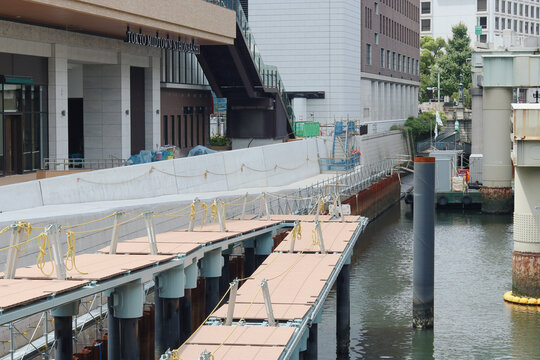 TOKYO, JAPAN - August 2, 2026: Riverside including Tokyo Midtown Nihonbashi and Shoto Expressway which is above  river. Nihonbashi bridge and Nomura Nihonbashi Heritage Building are in background. 
