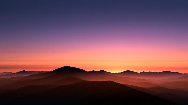 Misty Mountain Layers Silhouette at Colorful Sunset Sky