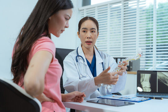 Doctor explains degenerative spinal disease after an Xray,  back pain, diagnosis, treatment, recovery, pain management, and prevention.