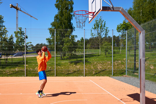 Young man training on the basketball court