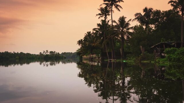 Beautiful boat ride through the serene backwaters of Kochi, Kerala, at sunset, surrounded by coconut palms, calm water, and lush tropical scenery, showcasing the peaceful beauty of South India.