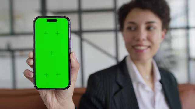 Professional Woman Showing Smartphone Green Screen