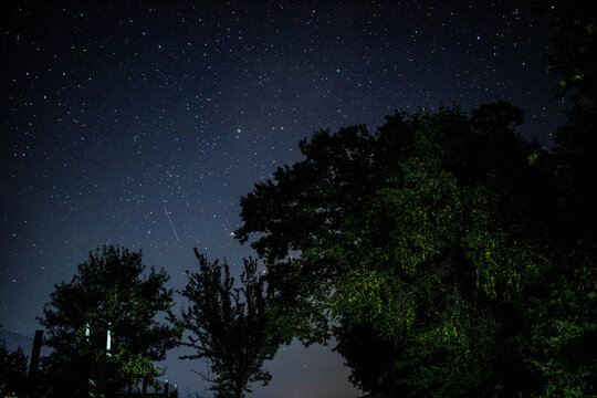 night sky with falling stars in the village