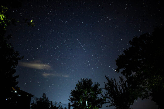 night sky with falling stars in the village